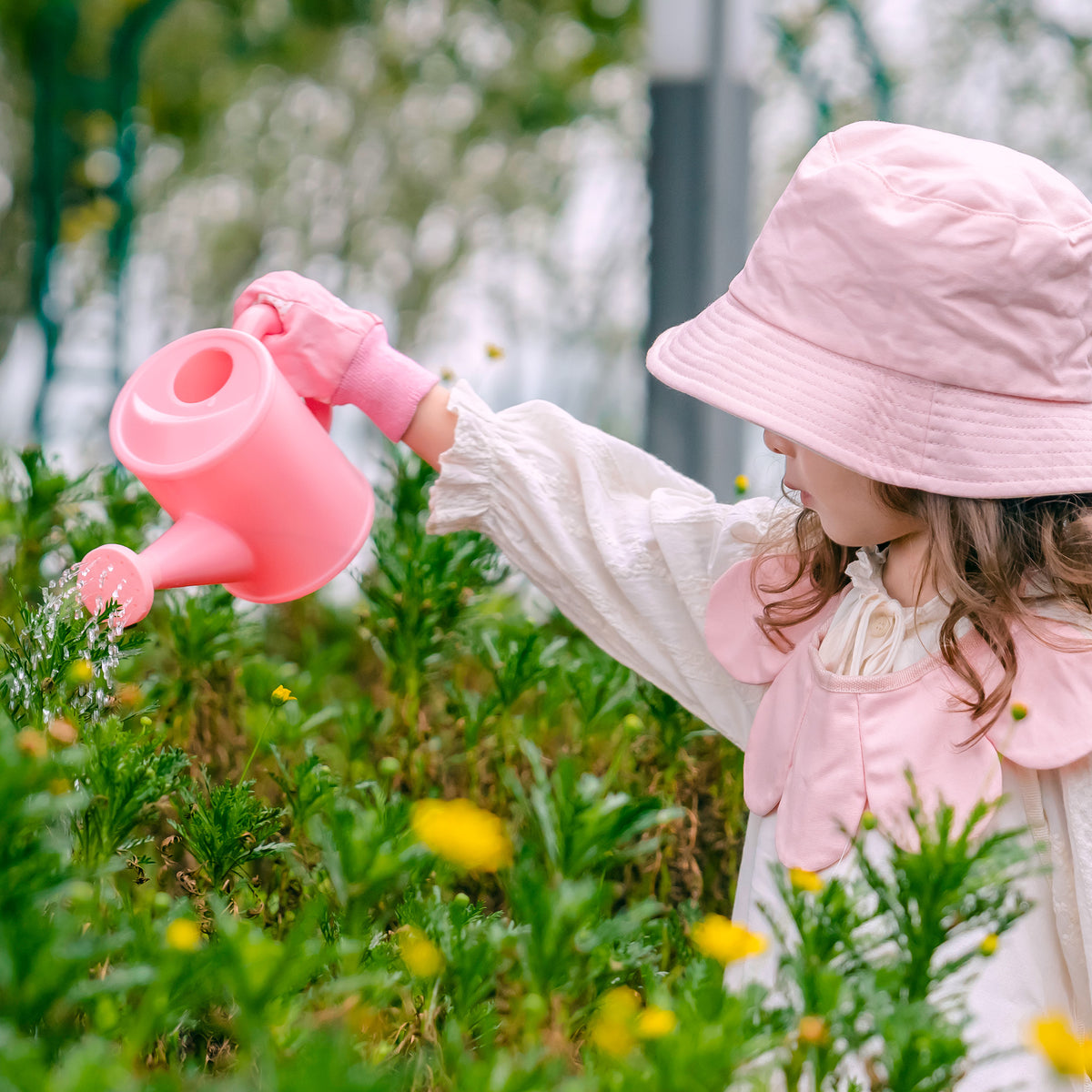 ROBUD Kids Gardening Set pink butterfly tote full set flat lay on white showing hat, apron, watering can, trowel, rake, fork and gloves