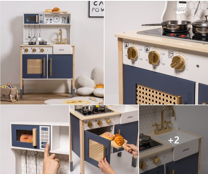 ROBUD navy blue and gold chef-style wooden play kitchen with cane panel oven door, microwave, sink, and golden hardware in a white tiled room setting