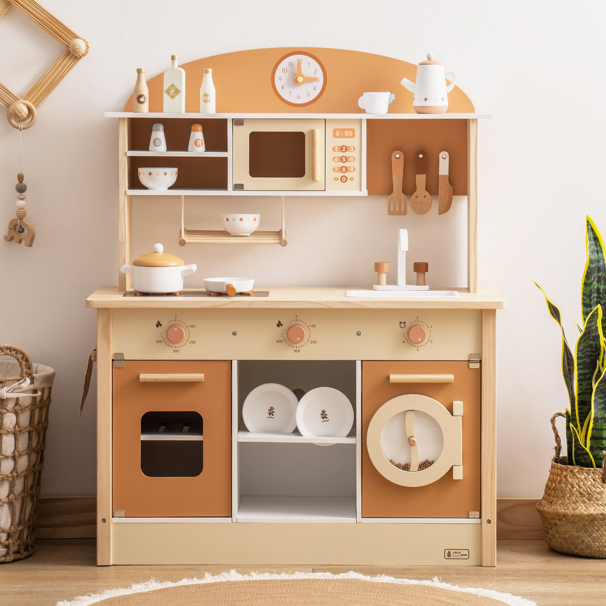 ROBUD Kids Caramel Kitchen full hero view showing stovetop with bowls, overhead shelves, clock and matching caramel cabinet doors