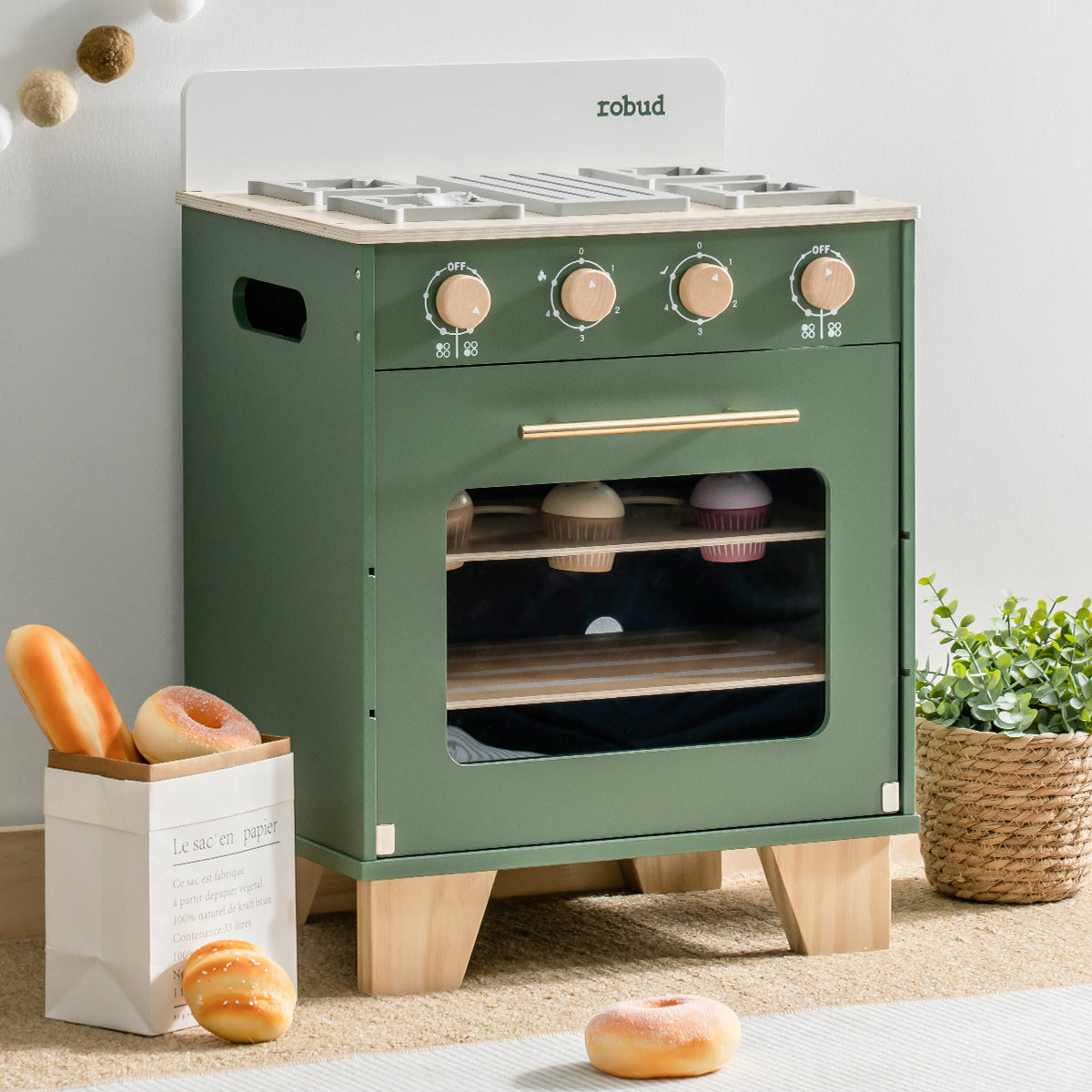 ROBUD vintage green toy kitchen oven with open door showing inner rack and toy bread loaves inside.