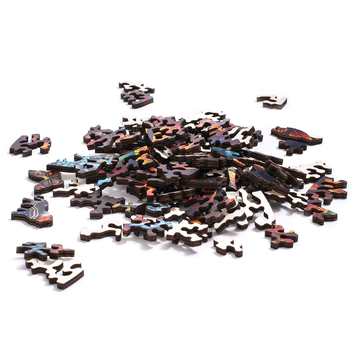 Loose dark wooden puzzle pieces from the Robotime Moonlight Owl jigsaw spread across a white surface