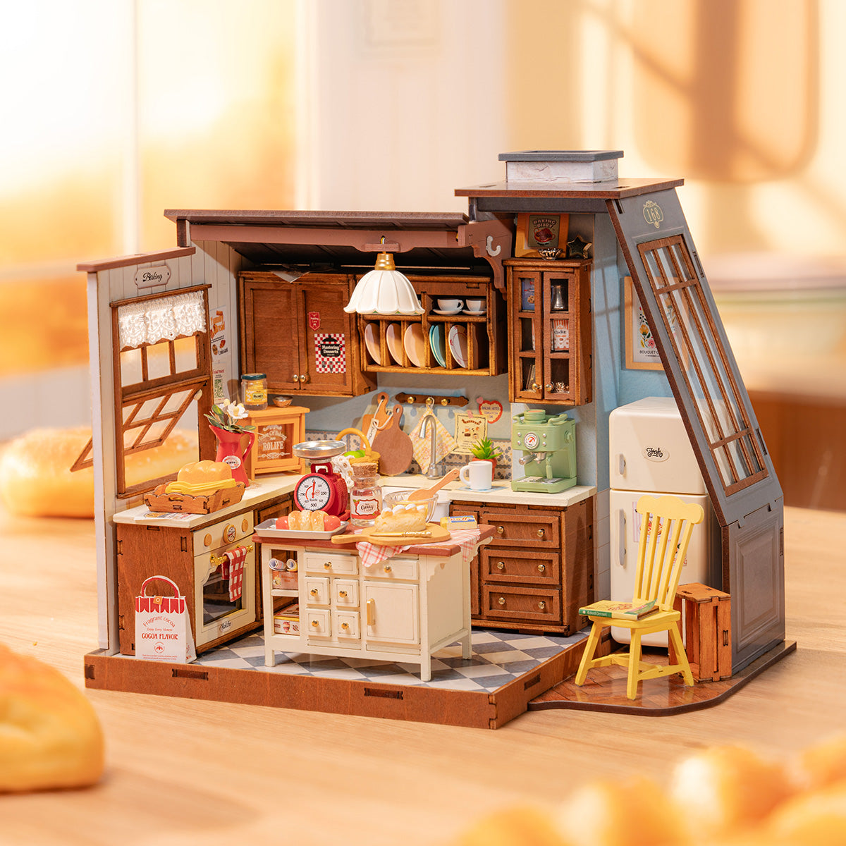 Rolife Baking Kitchen DIY Miniature House DG172 lifestyle scene showing the completed model on a sunlit wooden table surrounded by bread rolls in warm morning light