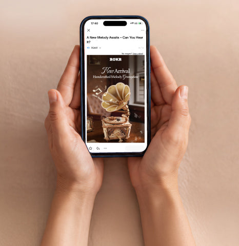 Hands holding a smartphone displaying an online store listing page for a vintage-style gramophone model kit