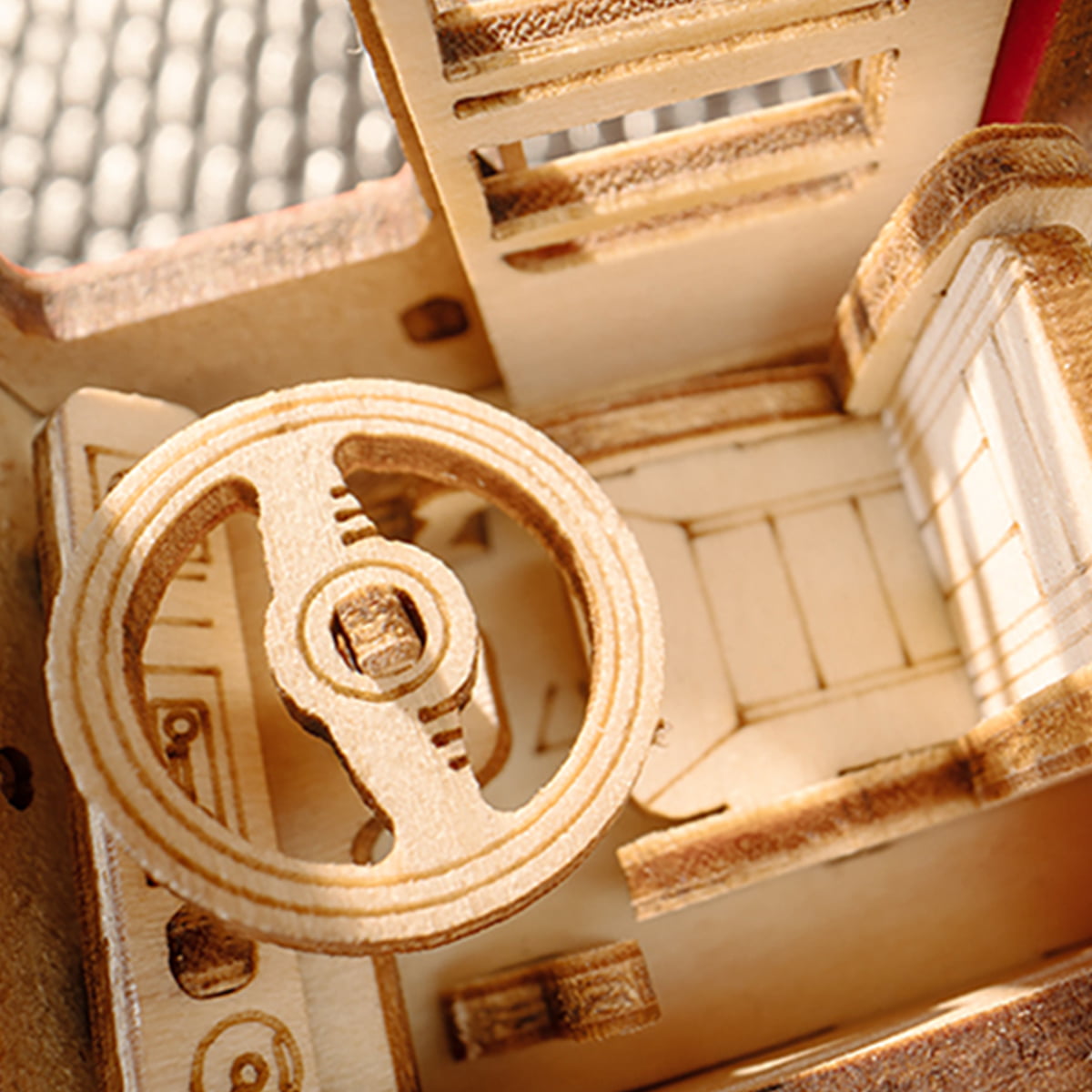 Rolife London Tour Bus wooden interior close-up showing steering wheel, dashboard and layered wooden floor detail