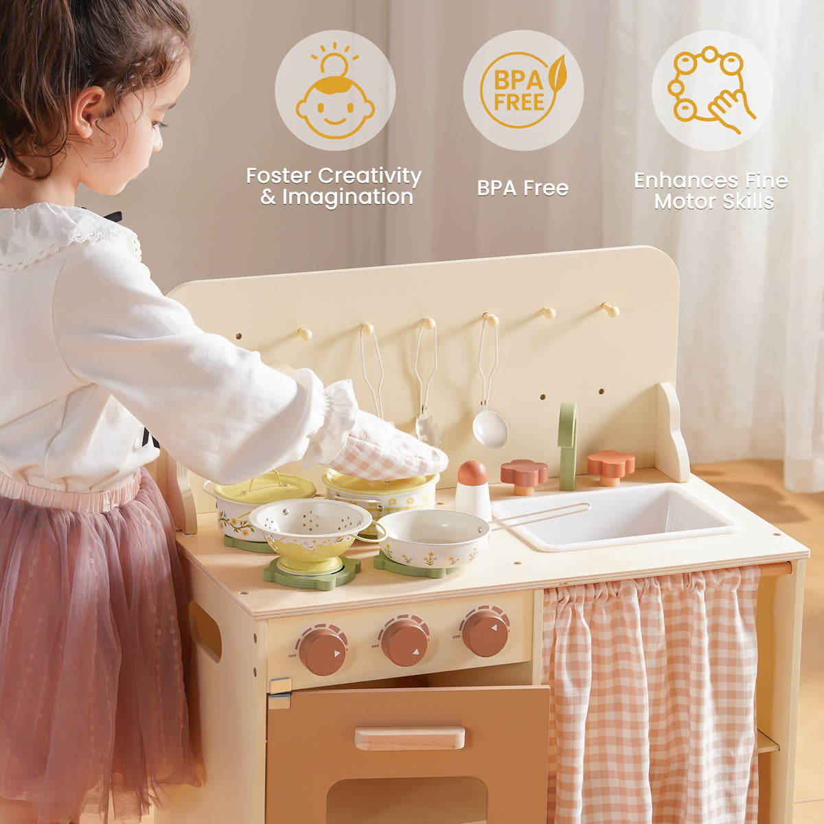Girl in pink kitchen playset playing with ROBUD Tinplate Pretend Cooking Utensils pink series pots and pans on wooden kitchen toy