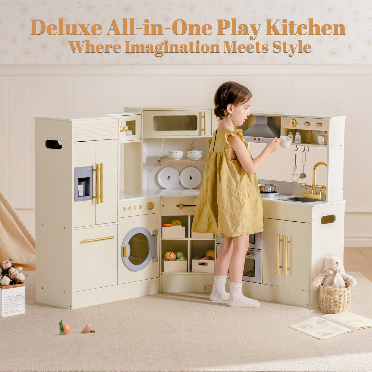 Young girl in yellow dress playing beside ROBUD Deluxe All-in-One Play Kitchen in cream and gold in bright playroom