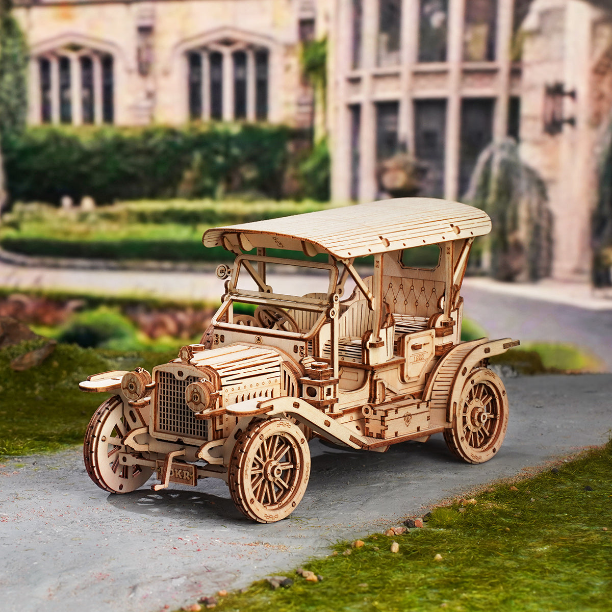 ROKR Vintage Car MC801 full-size natural wood vintage automobile posed on a garden path with stone architecture
