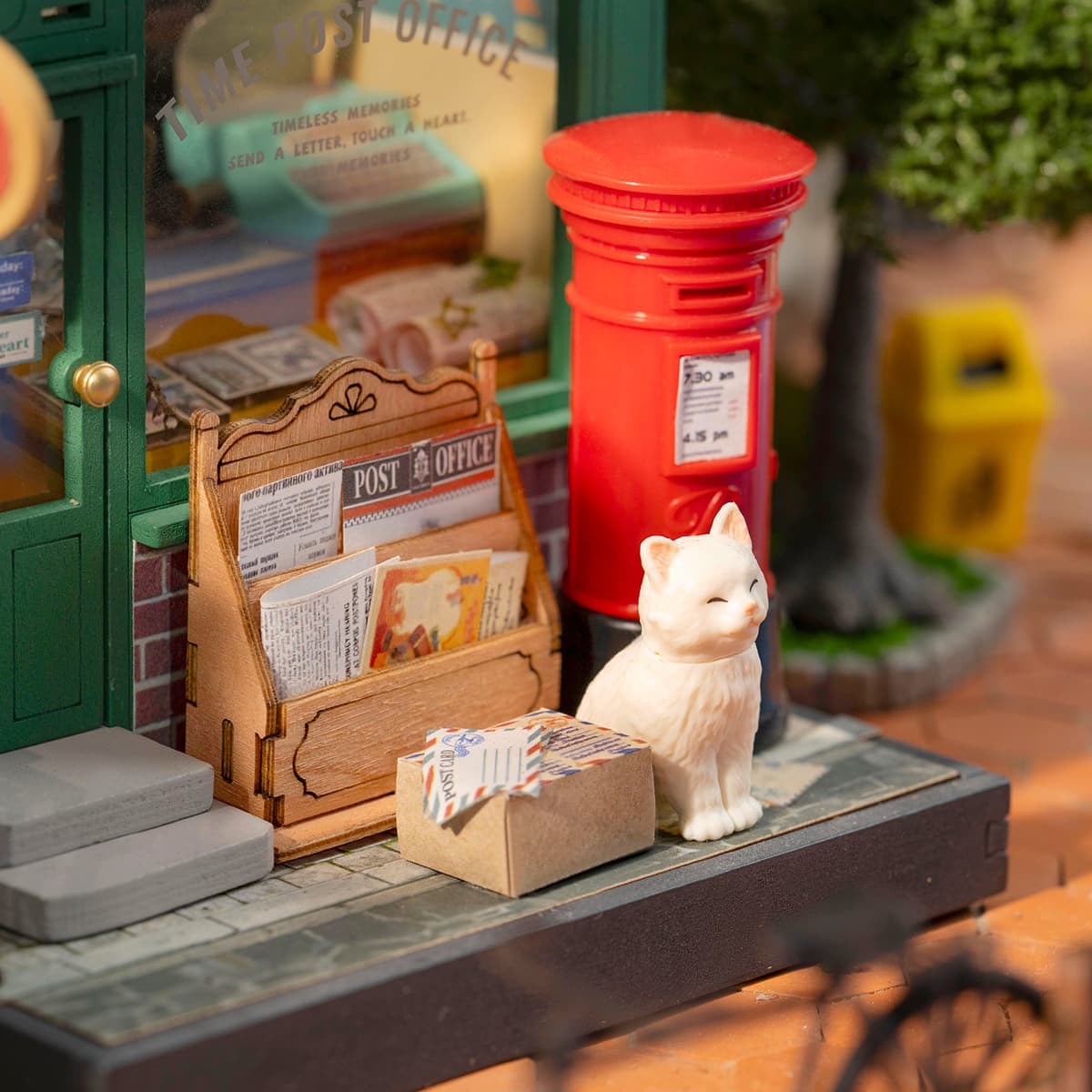 Rolife Century Post Office counter close-up with white cat figurine beside the red post box, letter rack and wrapped parcels