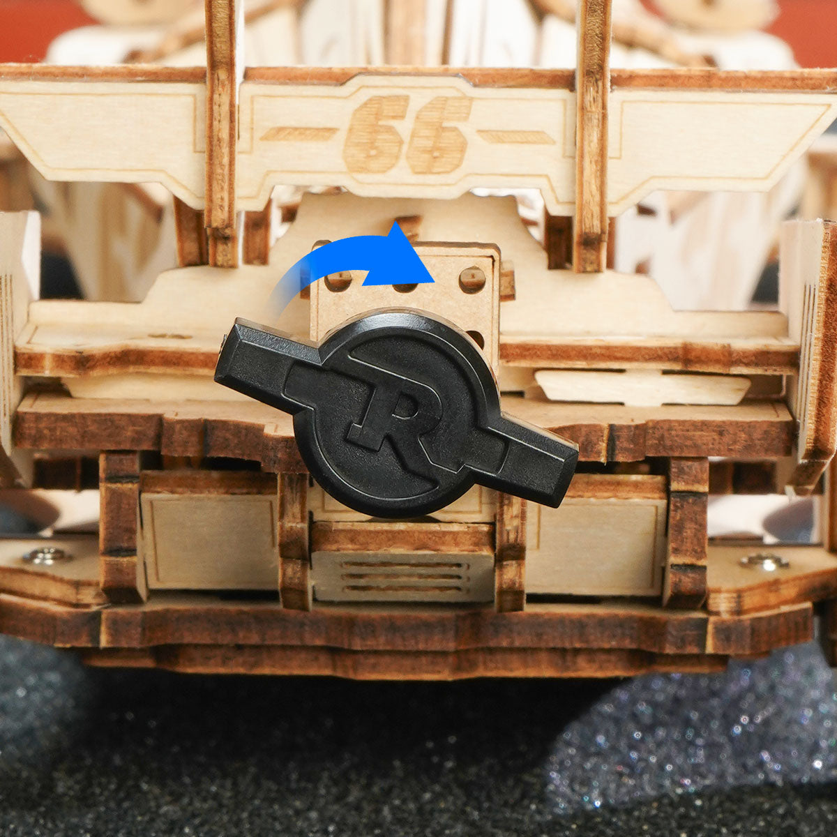 Close view of the ROKR racing car gear area with a black knob and blue directional arrows.