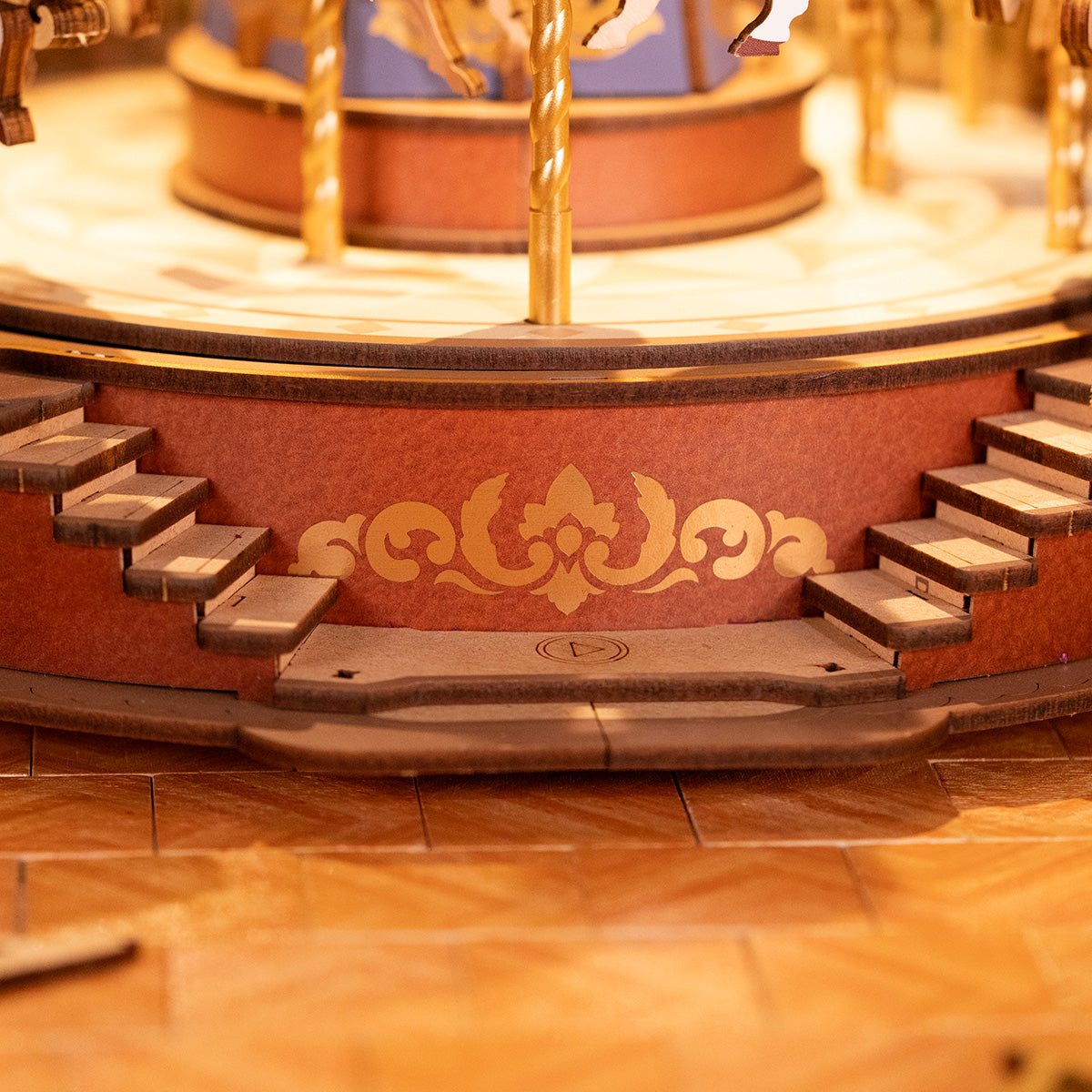 Rolife Classic Carousel AMC01 wooden base close-up showing dark brown ornate scroll inlay pattern on the rotating platform