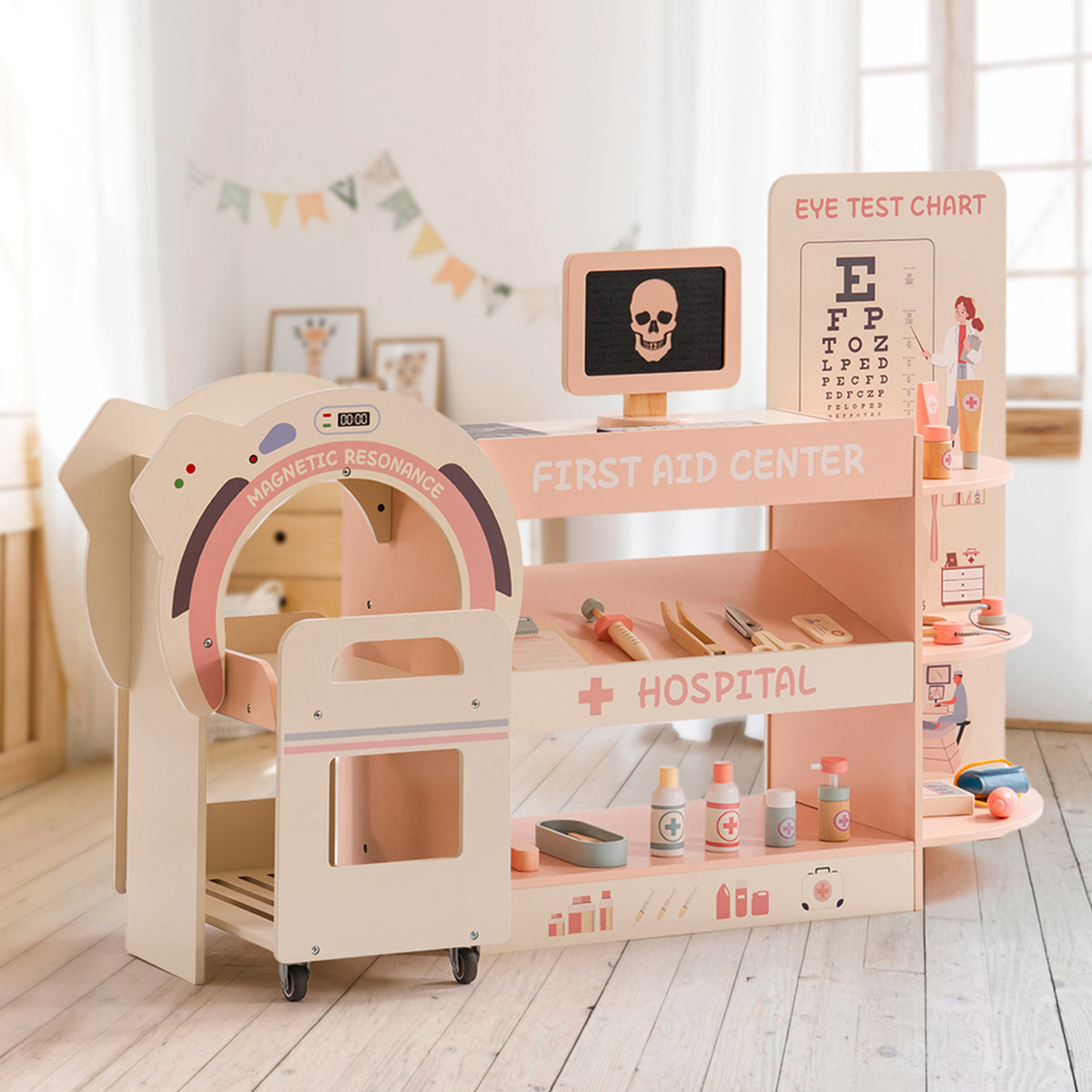 ROBUD wooden doctor activity center displayed in styled room with MRI machine, First Aid Center shelves and colorful pennant bunting
