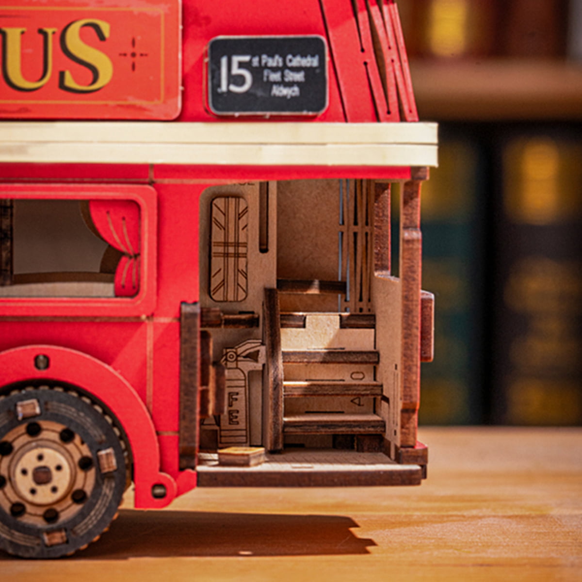 Rolife London Tour Bus interior close-up showing wooden cabin shelves and curtains through open red double-decker side panel