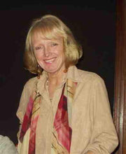 Robotime blog author portrait of Irena Nieslony, a smiling woman with blonde hair wearing a beige blouse and colorful scarf