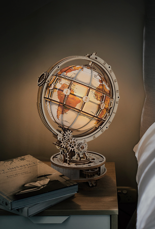 Robotime Curious Discovery collection theme graphic showing ROKR wooden globe glowing softly on bedside table at night