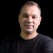 Portrait headshot of Robotime Online blog contributor Iftikhar A against a dark background wearing a black top