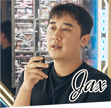 Portrait of Jax, Robotime brand collaborator, shown in a store surrounded by wooden puzzle products on shelves in the background