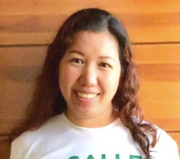 Jennifer Calapit blog author headshot smiling in a white shirt against a warm wooden panel background