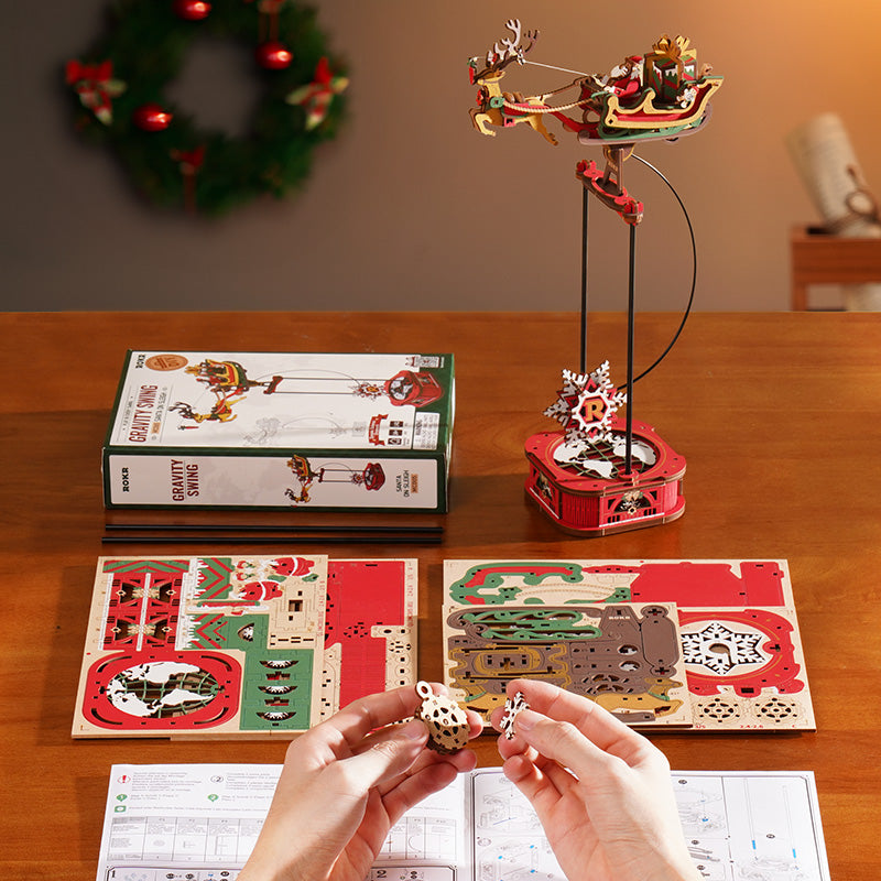 ROKR Santa on Sleigh MCD05 pendulum balance toy assembled product shot with holiday wreath and green tree in background