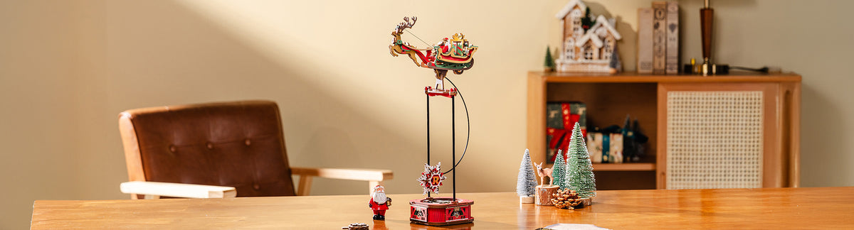 Robotime Gravity Swing collection desktop hero banner showing ROKR Santa on Sleigh pendulum toy on wooden desk wide format
