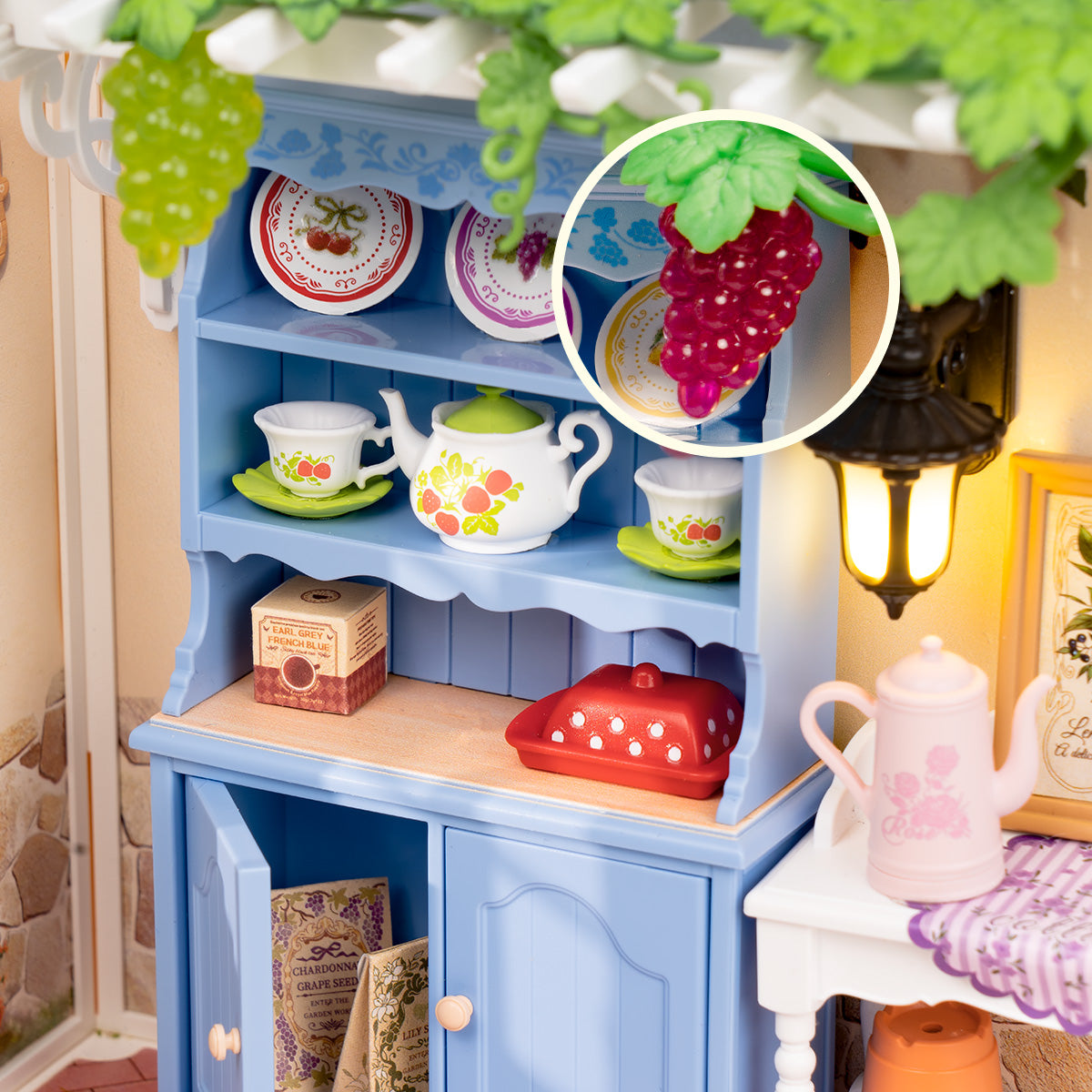 Rolife Midsummer Dream Yard DW025 hutch close-up highlighting grape cluster detail with circular magnification callout and warm lantern glow