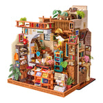 Rolife PageStory Books miniature front view with layered rooms, books, plants and warm lights