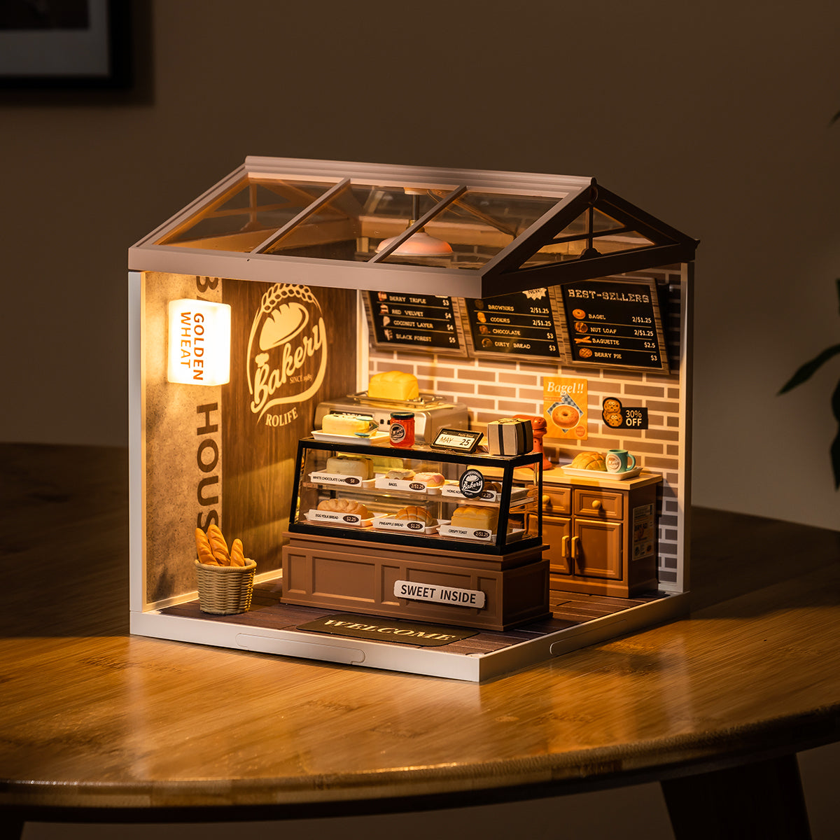 Rolife Super Creator bakery room glows inside a clear case with brick walls and a striped awning.