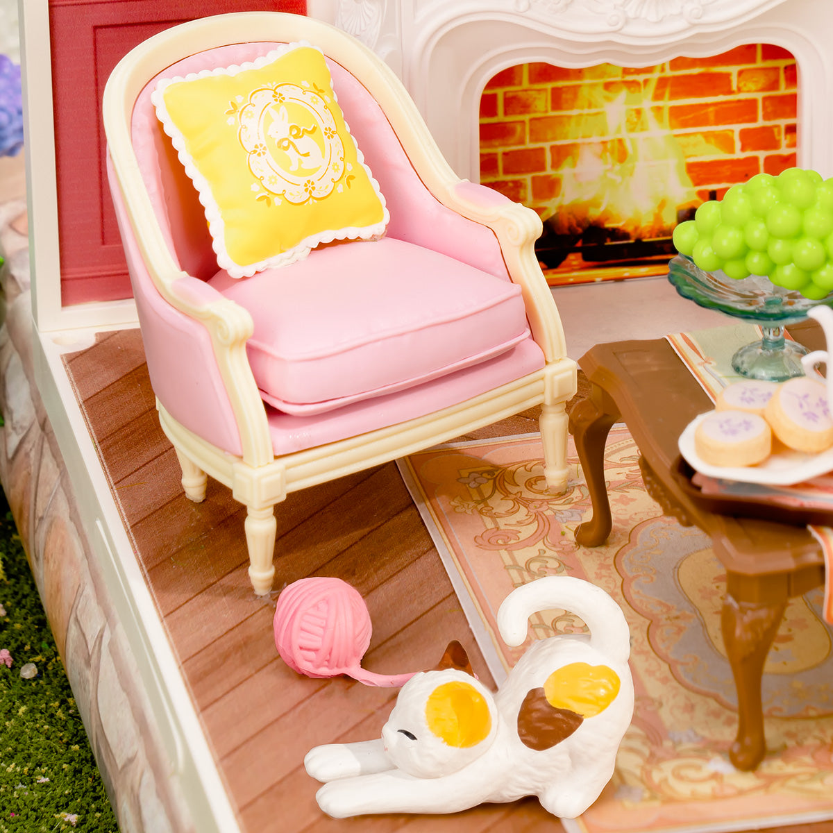 Rolife Holiday Tea Time DW023 pink armchair and white cat detail scene outdoors on a stone plinth surrounded by garden flowers