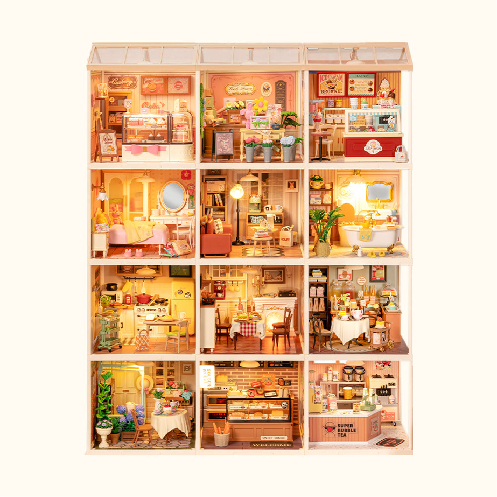 Multiple house kits combined, with lights on in each room.