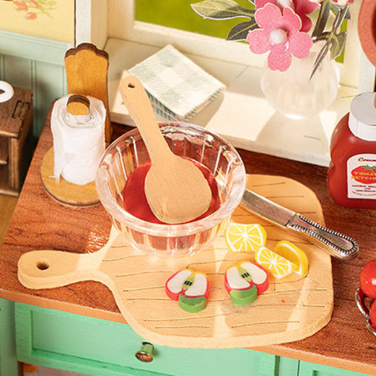 Rolife miniature kitchen detail with a glass bowl, wooden spoon and lemon slices on a wooden cutting board