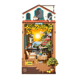 Rolife book nook miniature of a sunlit lemon garden cafe with terracotta planters, yellow fruit, and glowing interior light, hero product view on white background