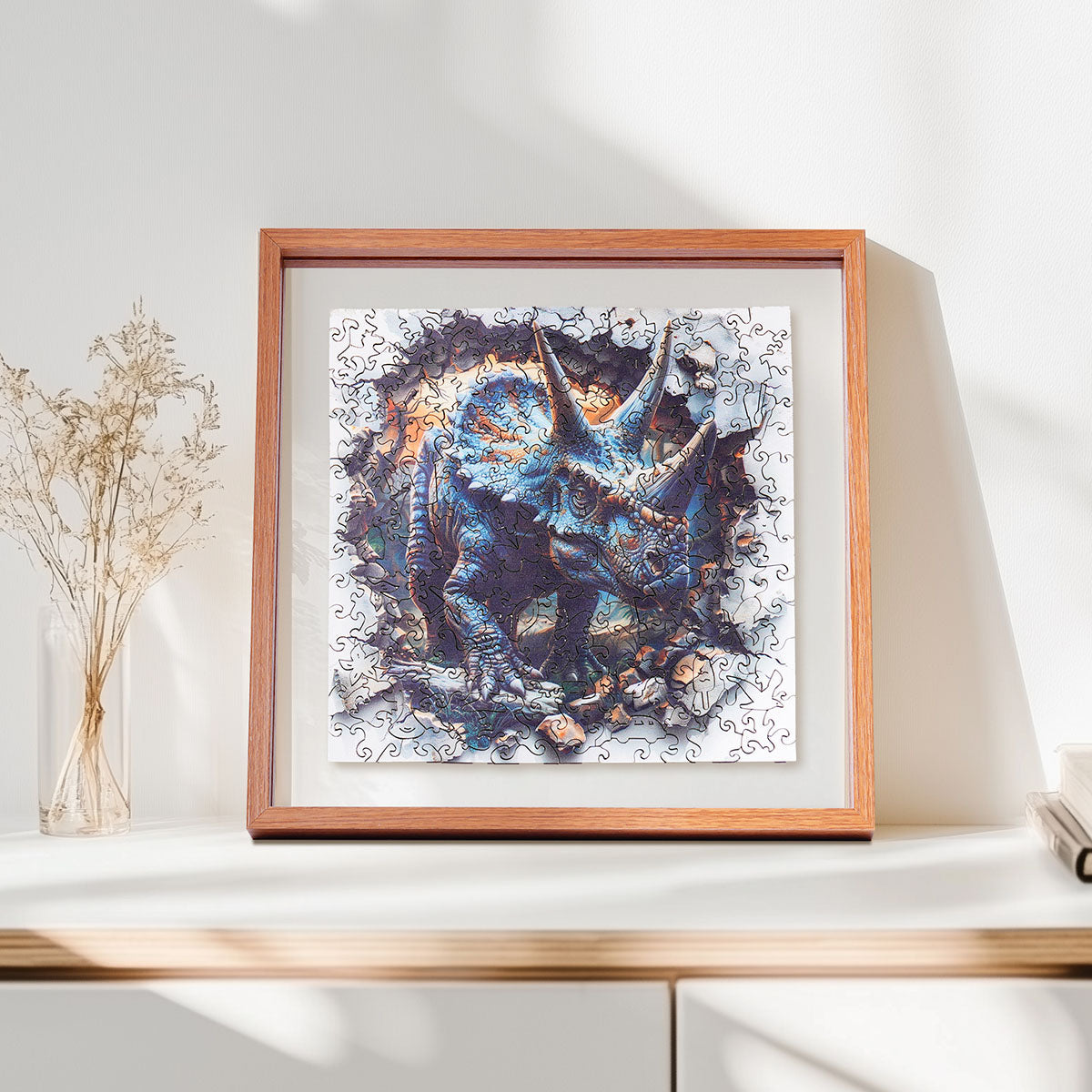 Rowood Wall Breaking Triceratops wooden jigsaw puzzle displayed in a 10.5 by 10.5 inch shadow box frame, showing front and side dimensions