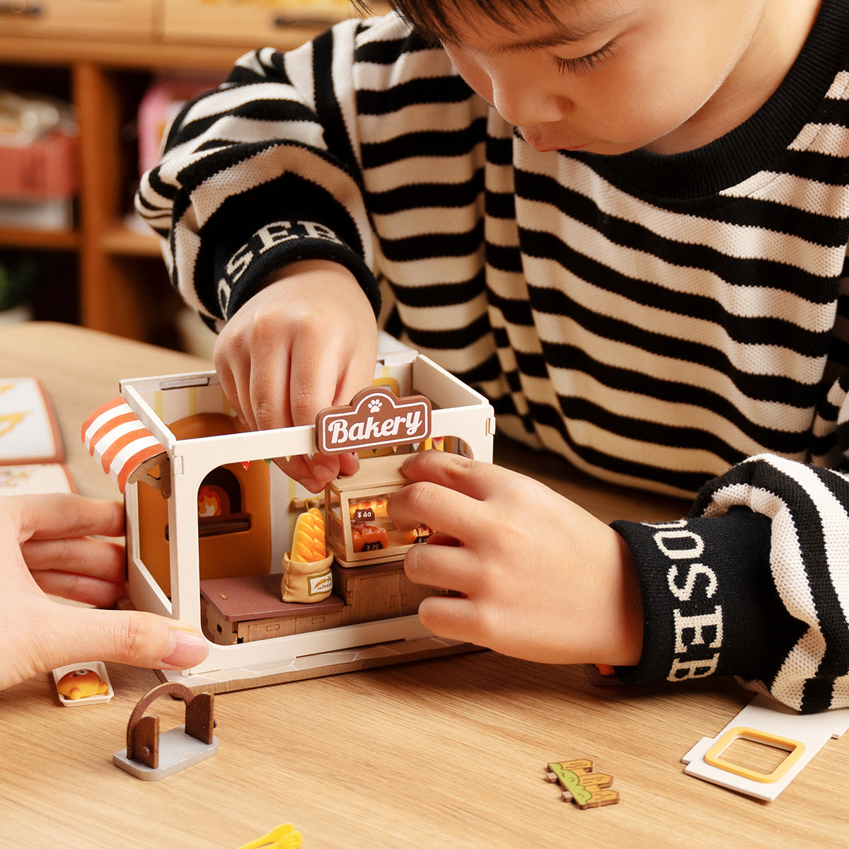 Rolife Food Box Shop DIY book nook miniature kit, angled three-quarter view of the build