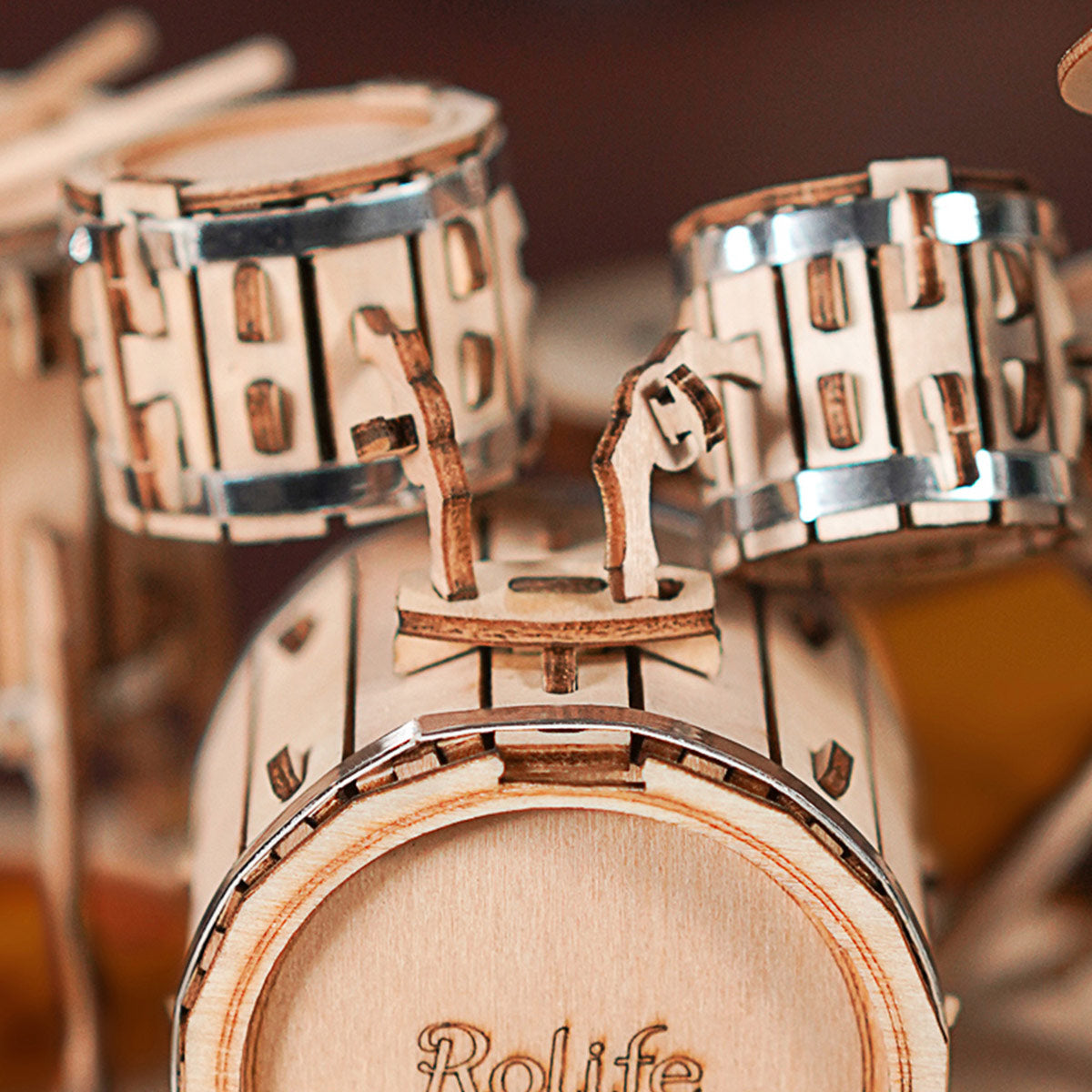 Rolife Drum Kit TG409 macro of kick drum face with brand engraving and snare hardware in birch