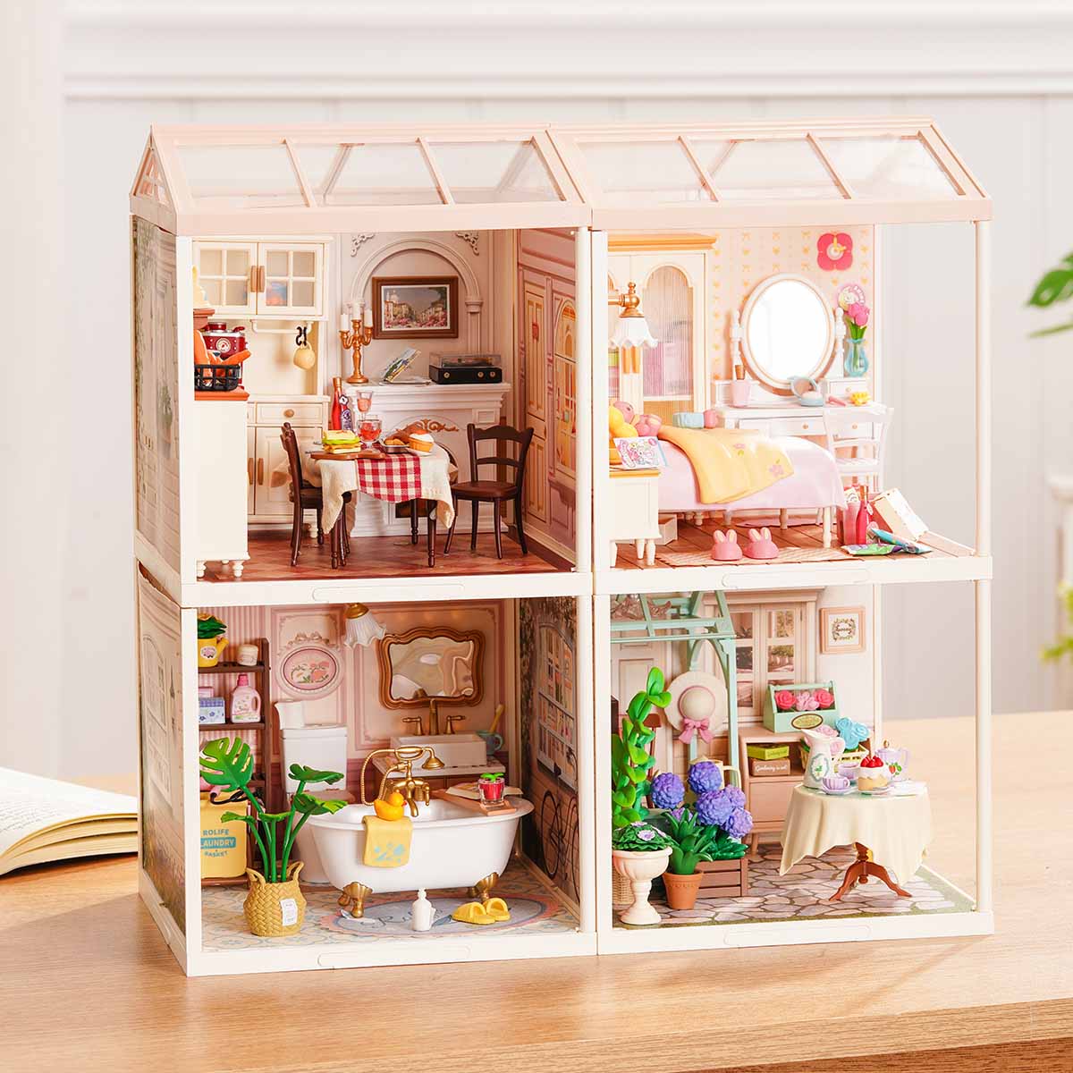 Rolife Super Creator Series 4-in-1 Four Grid miniature with dining room and pink bedroom on top and bathroom with clawfoot tub and garden tea room below in a two-by-two frame.