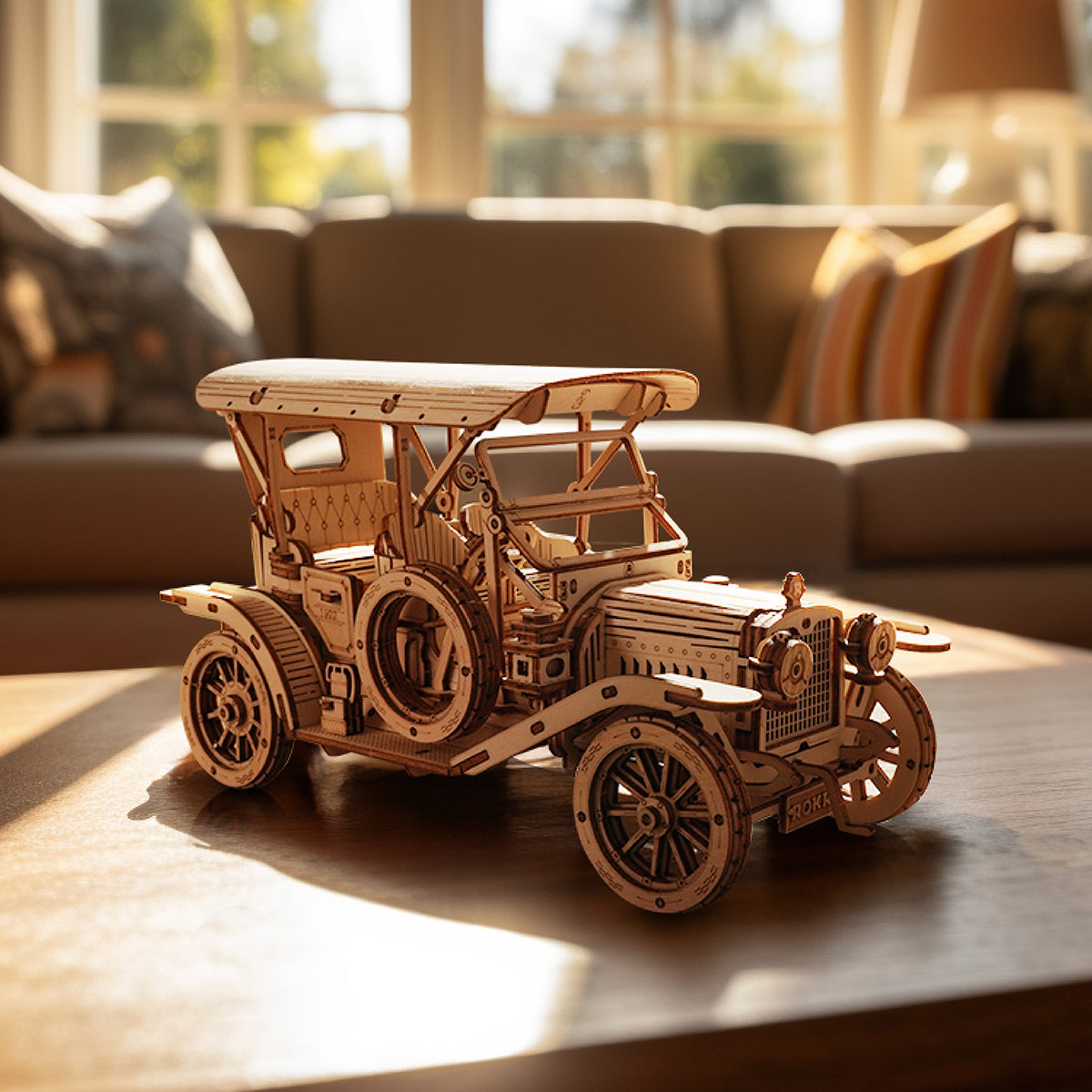 ROKR Vintage Car MC801 assembled natural wood antique automobile glowing in warm sunlight on a coffee table
