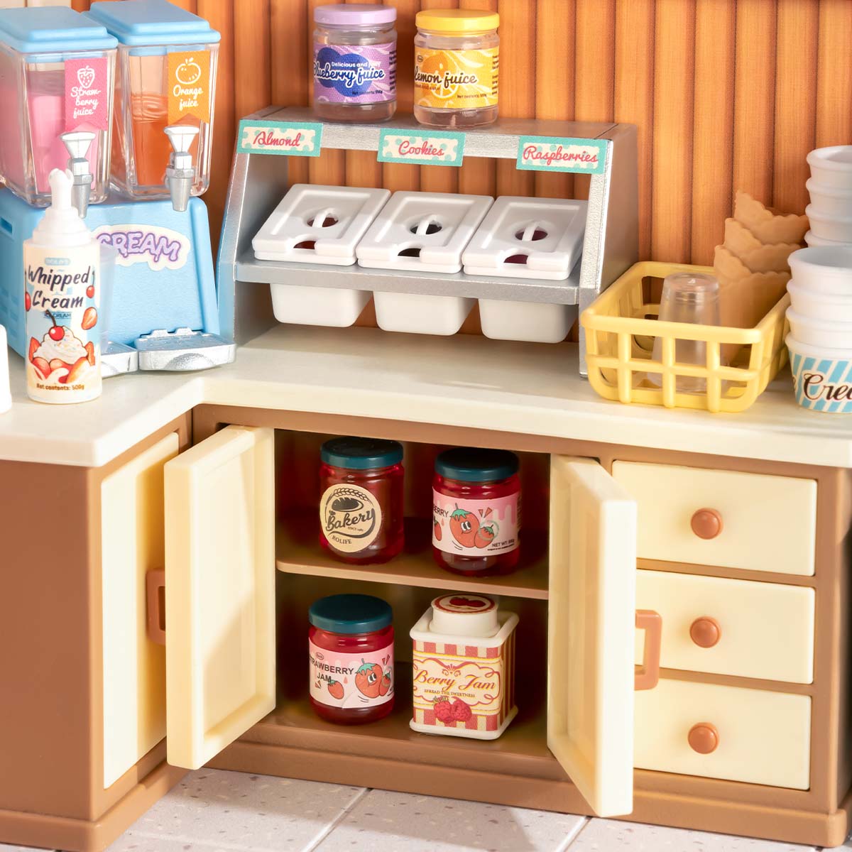 Rolife Flavorful Ice Cream DIY miniature house DW018B top-down overhead view showing the ice cream parlor interior with red counter, ice cream machine, brownies sign, and seating area.