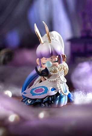 Rolife fantasy Nanci doll in purple and blue dress with rabbit ears and pearl accents posed against a soft purple draped background