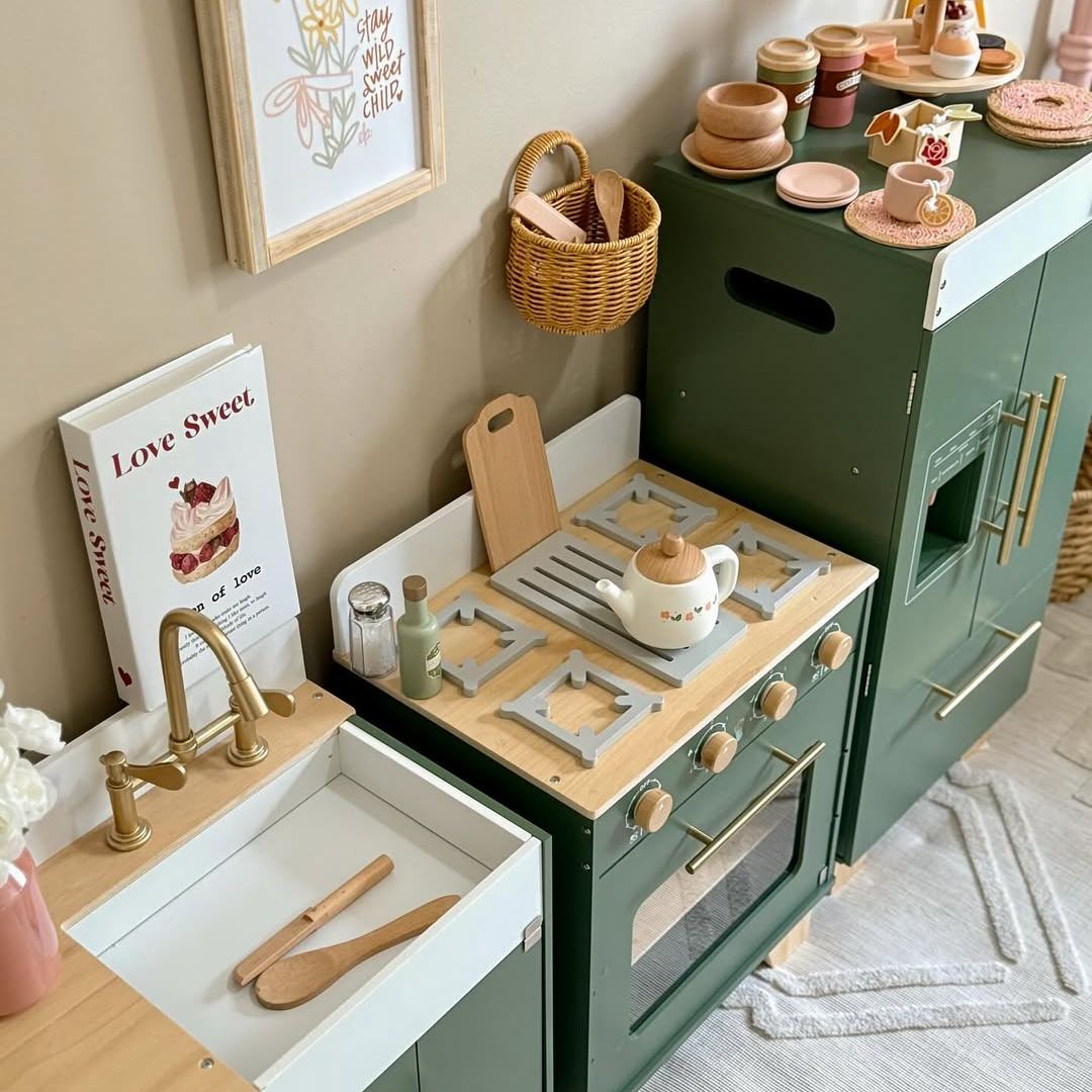 Side view of ROBUD vintage green play kitchen sink and oven showing wooden cutting board and tongs on pull-out drawer