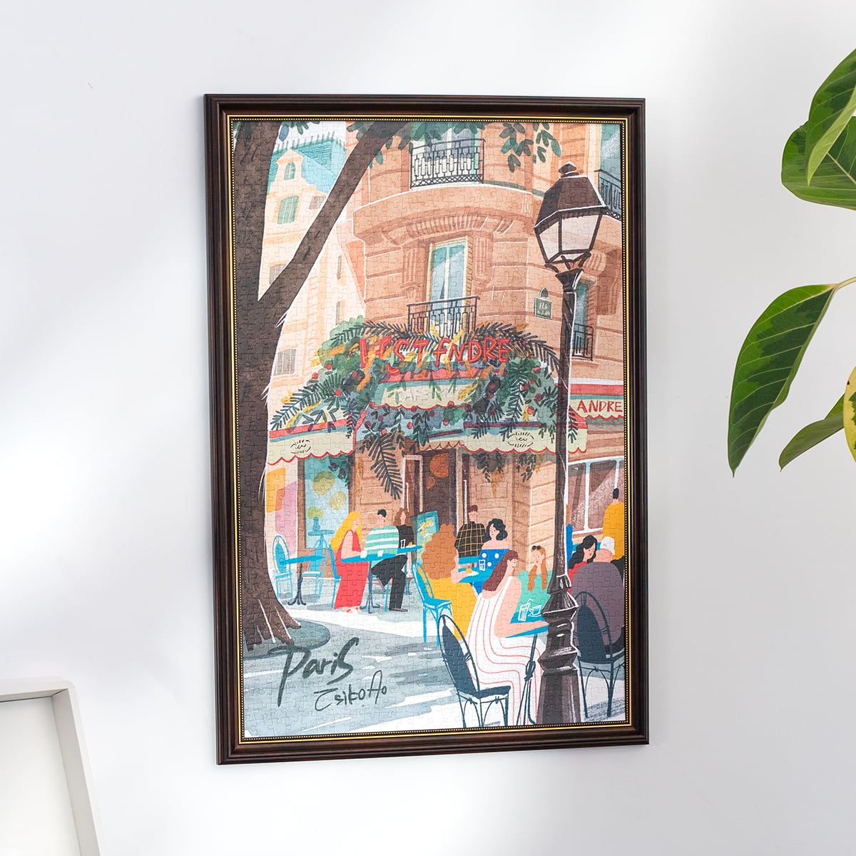 Rolife Leisure in Paris PT004 puzzle framed and hung on white wall with illustrated cafe terrace and warm street lamp scene